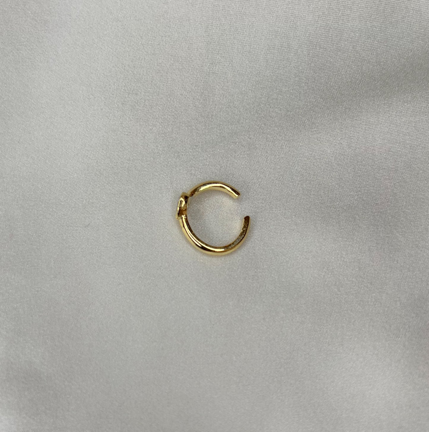 simple gold ear cuff with heart shaped diamond