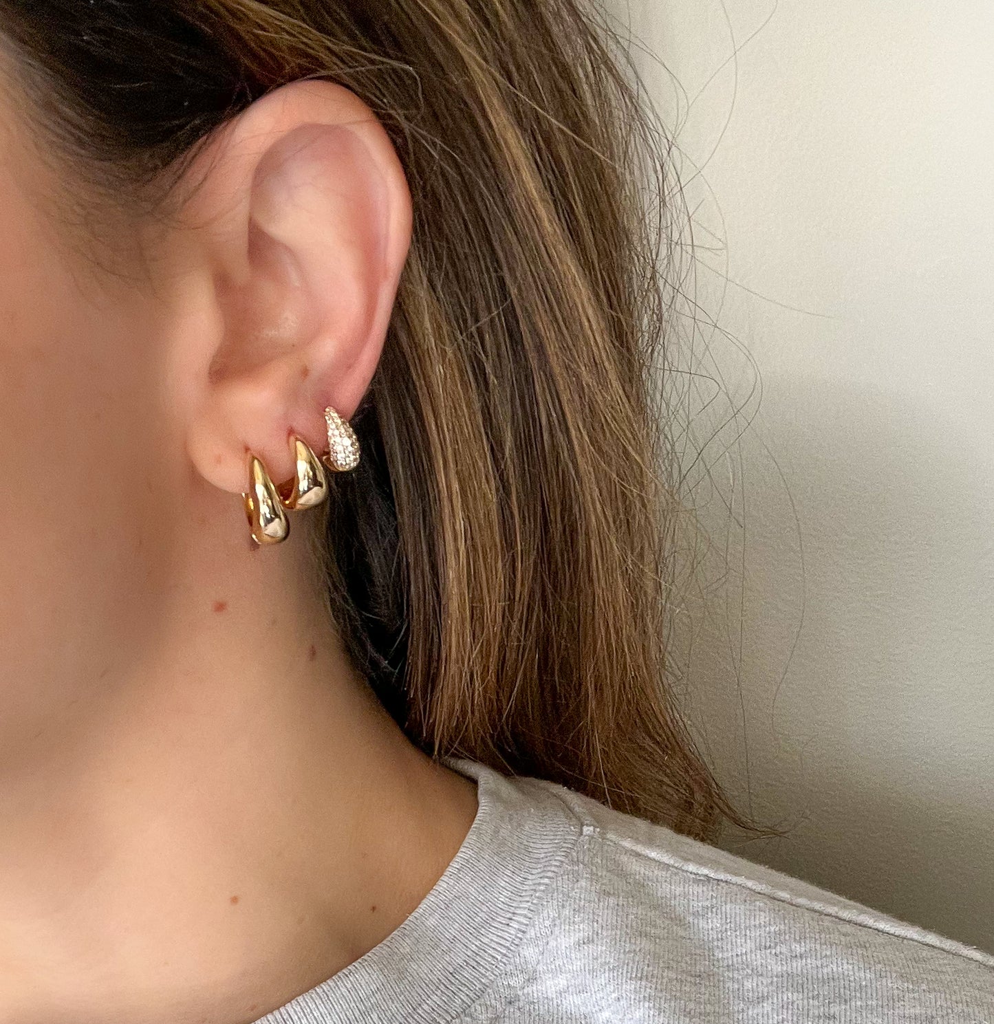 earring set. 3 pairs of teardrop shaped chunky gold hoops . Mix and match earrings. 16mm waterproof gold hoops. 13mm waterproof gold hoops. 10mm micro pave gold huggies.
