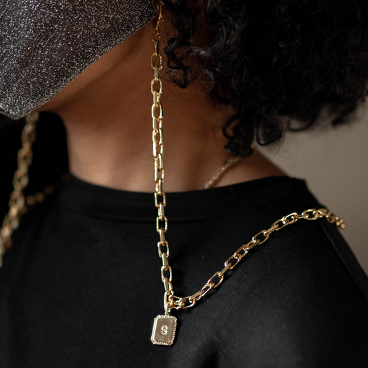 gold chain with gold initial tag pendant