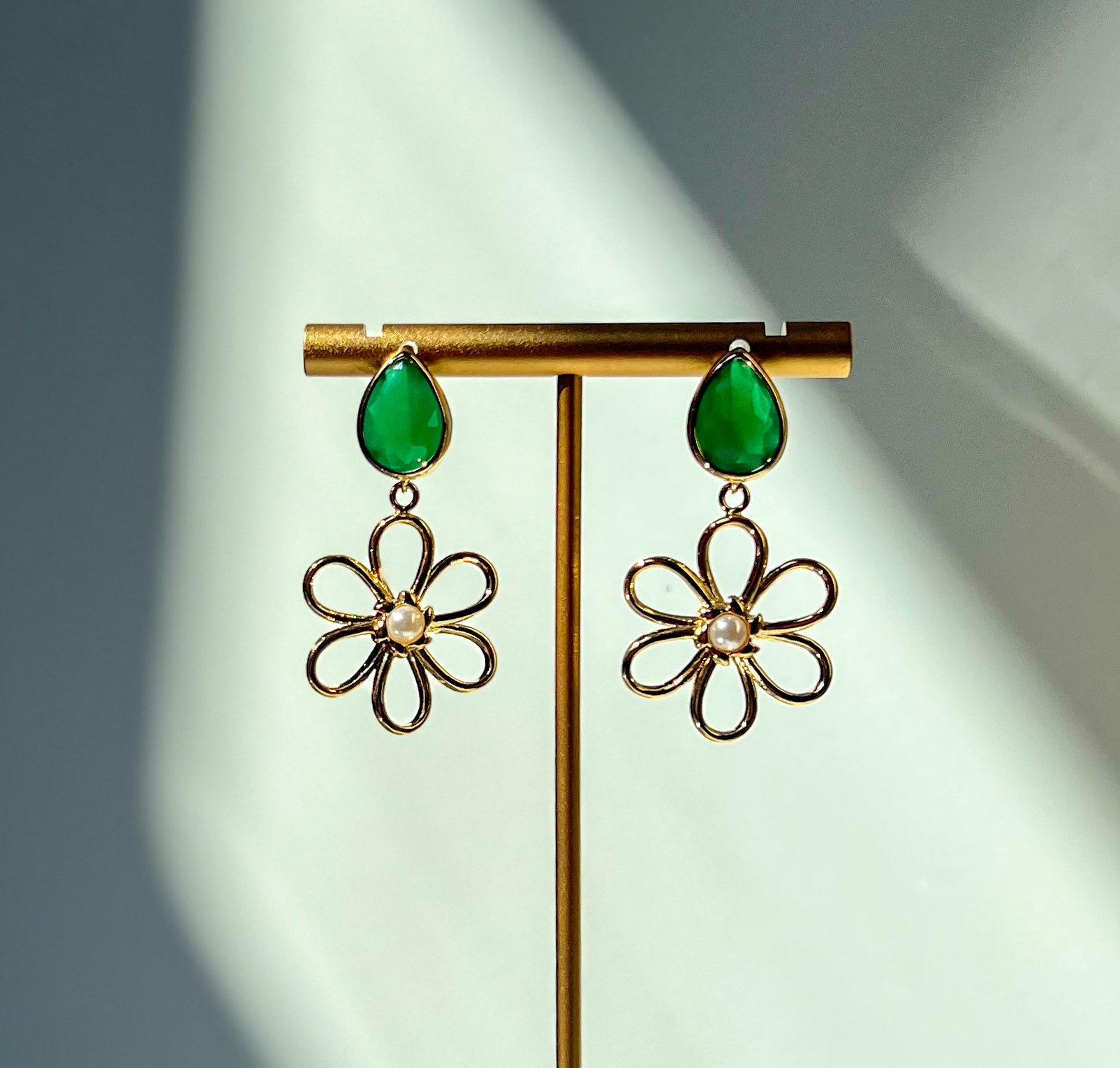 gold flower earrings. flower earrings. gold flower jewelry. emerald green earrings. gold and emerald earrings. emerald earrings. emerald green jewelry. emerald green earrings. colorful gemstone earrings. colorful statement earrings. trendy earrings. affordable fun earrings. gemstone jewelry. trendy jewelry brand. trendy earrings. trendy jewelry style