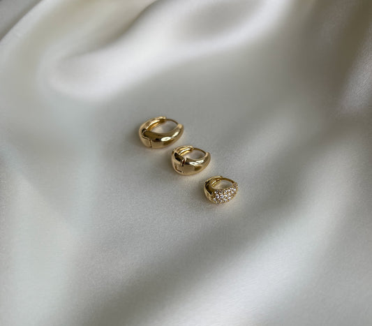 earring set. 3 pairs of teardrop shaped chunky gold hoops . Mix and match earrings. 16mm waterproof gold hoops. 13mm waterproof gold hoops. 10mm micro pave gold huggies.