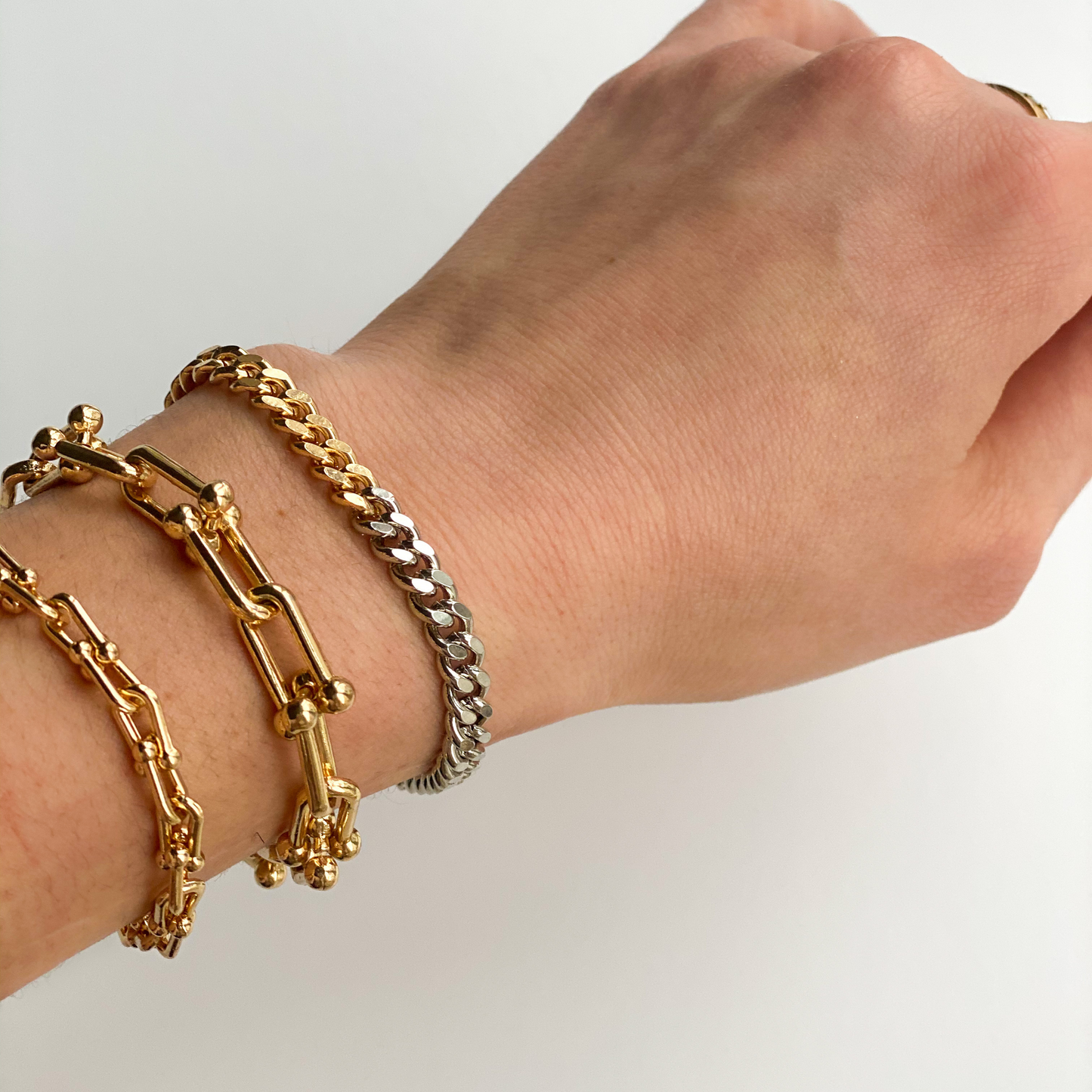 two-tone gold and silver curb chain bracelet and two gold u link chain bracelets