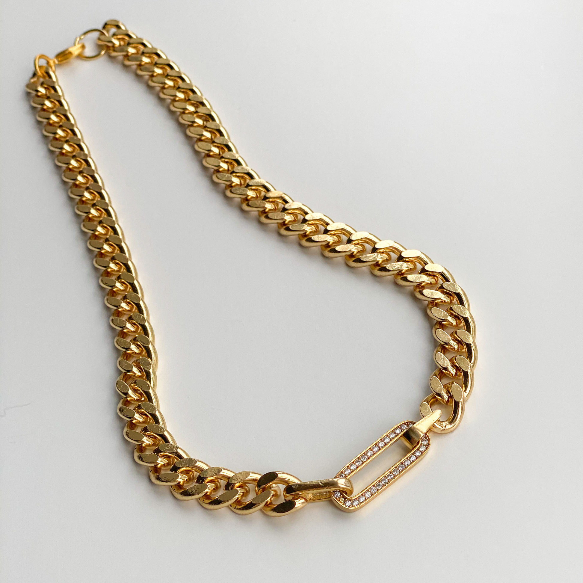 gold curb chain necklace with diamond studded link 